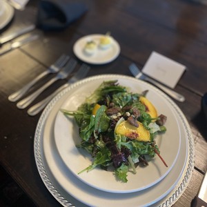 Place setting with salad and peaches